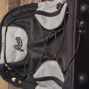 ROOTS WHEELED CARRY ON.  NUMEROUS COMPARTMENTS.  GENTLY USED.